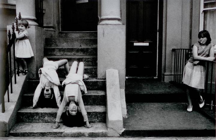 Marketa Luskačová -  "Girls upside down". Blenheim Crescent, London, 1984, from the series 'Children in Britain'.